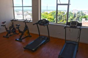 a gym with exercise bikes in a room with windows at Nuevo Hotel Ancasti in San Fernando del Valle de Catamarca
