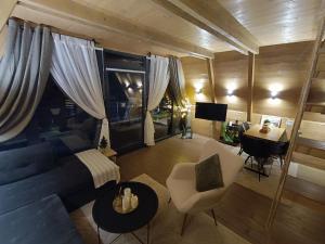 a living room with a blue couch and a table at Stone Chalets - LUNA in Jajce