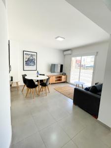 a living room with a couch and a table at Saavedra 118 1°H by depptö in Bahía Blanca