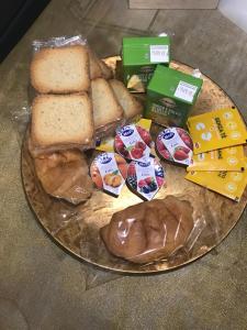 a plate of food with bread sandwiches and other foods at Gold house in Ravenna