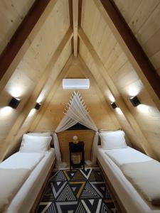 a room with two beds in a attic at Stone Chalets - LUNA in Jajce