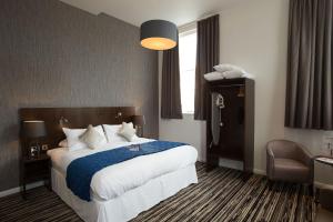 a hotel room with a large bed and a window at The Furness Railway Wetherspoon in Barrow in Furness