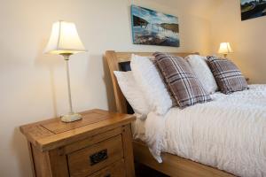 a bedroom with a bed and a lamp on a night stand at Kettle House B&B in Fort Augustus