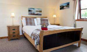 a bedroom with a bed with a stuffed animal on it at Kettle House B&B in Fort Augustus