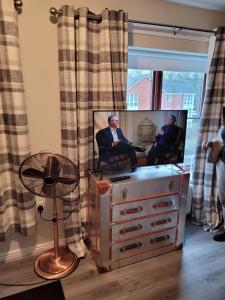 a man sitting in a chair in front of a mirror at 75 Park Prewett in Basingstoke