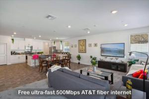 a large living room with a couch and a kitchen at Entire Private 4-BR, Mountain Edge, New House, Ranch, Gated Yard, Available Now in Menifee