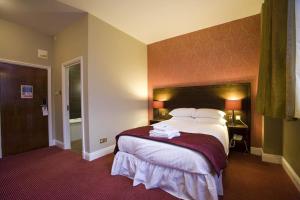 a bedroom with a large bed in a hotel room at The Briar Rose Wetherspoon in Birmingham