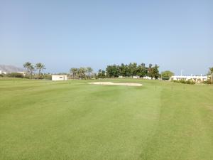 a view of the green at a golf course at Sifah Seascape House in Muscat