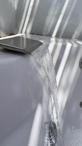 a bath tub with a faucet with water coming out at Casa AguaMarina in Honda