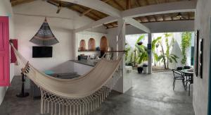 a swinging hammock in a room with a kitchen at Casa AguaMarina in Honda