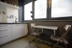 a kitchen with two chairs and a table in it at Apartament Azer Eforie Nord in Eforie