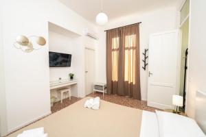 Postel nebo postele na pokoji v ubytování Valguarnera Studio Apartments
