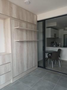 a dining room with a table and a glass door at La posada de Mayté in Santa Marta