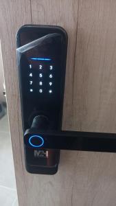 a remote control sticking out of a wooden door at La posada de Mayté in Santa Marta