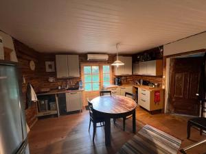 a kitchen with a table and chairs in a room at Privaatne talu otse mere ääres in Tahkuranna