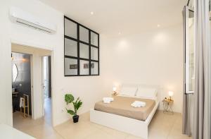 Postel nebo postele na pokoji v ubytování Valguarnera Studio Apartments