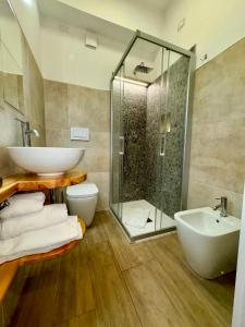a bathroom with a shower and a sink and a toilet at Hotel Lo Sciatore in San Massimo +44 photos