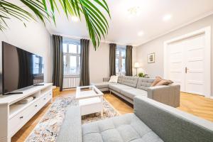 a living room with a couch and a tv at Casa Linda Zagreb - FREE PARKING in Zagreb