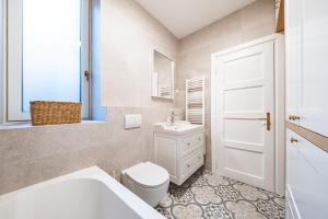 a white bathroom with a toilet and a sink at Casa Linda Zagreb - FREE PARKING in Zagreb +35 photos