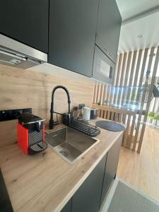 a kitchen with a sink and a counter top at Tiny house in São Brás de Alportel