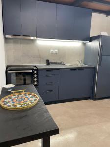 a kitchen with a table with a pizza on it at Loft by the sea in Amfilochia
