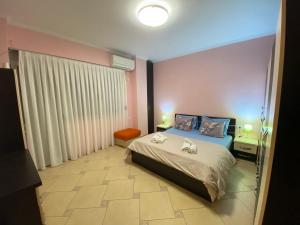 a bedroom with a bed with two towels on it at Tirana Center Apartaments in Tirana