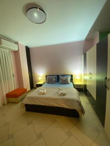 a bedroom with a bed with two towels on it at Tirana Center Apartaments in Tirana