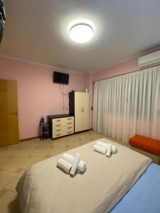 a bedroom with a large bed with towels on it at Tirana Center Apartaments in Tirana