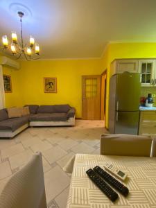 a living room with a couch and a refrigerator at Tirana Center Apartaments in Tirana