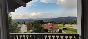 a view from a balcony of a house and mountains at Two Apartaments Almberg - Mitterdorf-Mitterfirmiansreut in Mitterfirmiansreut