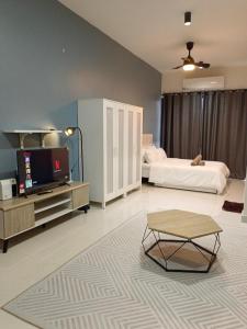 a large room with two beds and a tv in it at KLIA AIRPORT HOMESTAY in Sepang