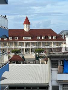 a large building with a clock tower on top of it at Tahiti Sunshine in Papeete