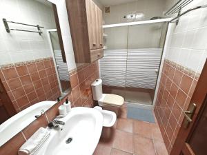 a bathroom with a sink and a toilet and a shower at Esencia de Sal in San Antonio +12 photos