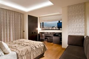 a hotel room with a bed and a desk at O&B Athens Boutique Hotel in Athens