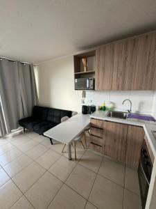 a kitchen with a couch and a table in a room at Depasfs in Santiago