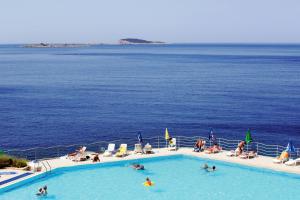 a pool on a cruise ship with people in the water at Apartments and rooms with parking space Plat, Dubrovnik - 23567 in Mlini