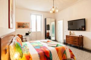 a bedroom with a bed and a flat screen tv at Vatica B&B Roma in Rome