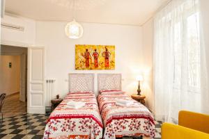 a bedroom with a bed with a red and white bedspread at Vatica B&B Roma in Rome