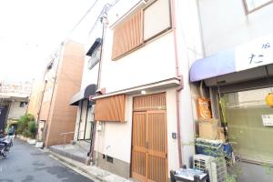 a building with a door on the side of a street at Ideal Momodani イデアール桃谷 in Osaka