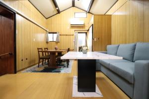 a living room with a couch and a table at Ideal Momodani イデアール桃谷 in Osaka