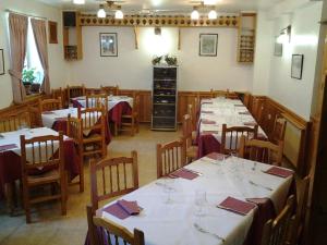 a dining room with tables and chairs with wine glasses at Villa Maria in La Virgen de la Vega