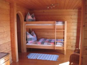 a wooden cabin with two bunk beds in it at Ferienhaus Höllwart in Pfarrwerfen