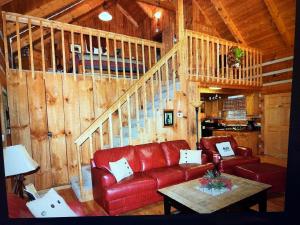 a living room with a red couch and a table at Mountain Hideaway in Pigeon Forge