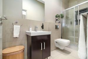 a bathroom with a sink and a toilet at Meerendahl Luxury Apartments at Heritage Square in Durbanville +50 photos