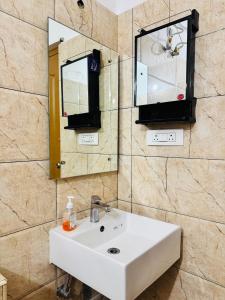 a bathroom with a sink and a mirror at 6Floor in society Ecity ph2 Near TCS Tech Mahindra in Bengaluru