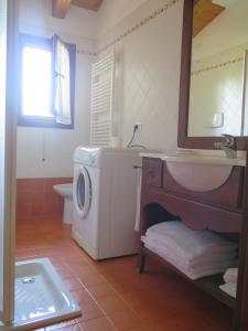 a bathroom with a washing machine and a sink at Tenuta Lio Maggiore in Lido di Jesolo
