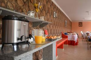 a kitchen with a coffee maker on a counter at Pousada Al Chaddai in São Lourenço