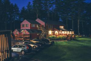 two cars parked in front of a house at night at Old Saco Inn in Fryeburg