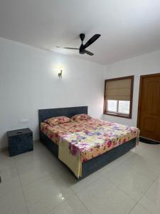 a bedroom with a bed and a ceiling fan at 6Floor in society Ecity ph2 Near TCS Tech Mahindra in Bengaluru