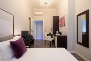 Postel nebo postele na pokoji v ubytování Arenula Suites